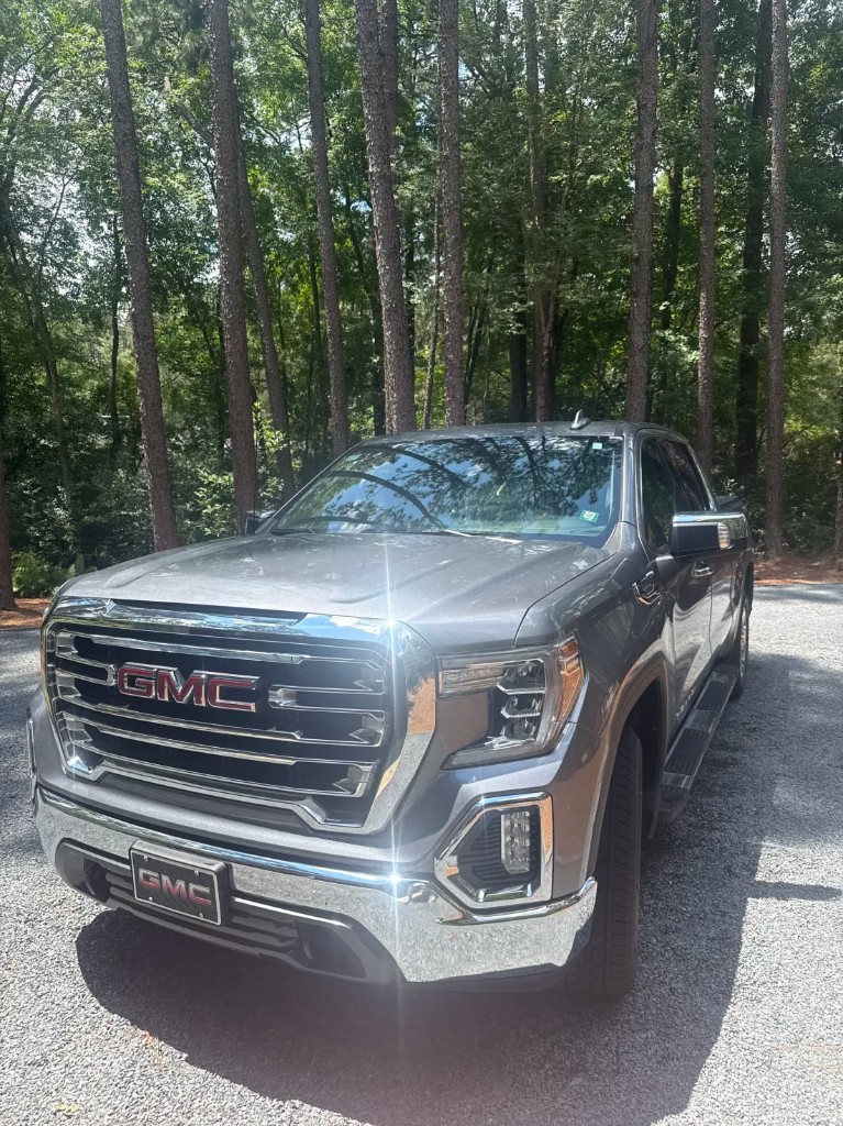 Freshly detailed metallic gray GMC Sierra with glossy paint and polished chrome